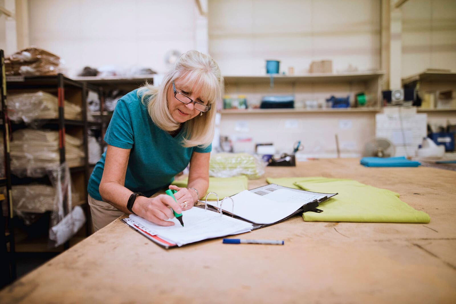 Small business owner checking commercial finance information and cash flow with stock around her.